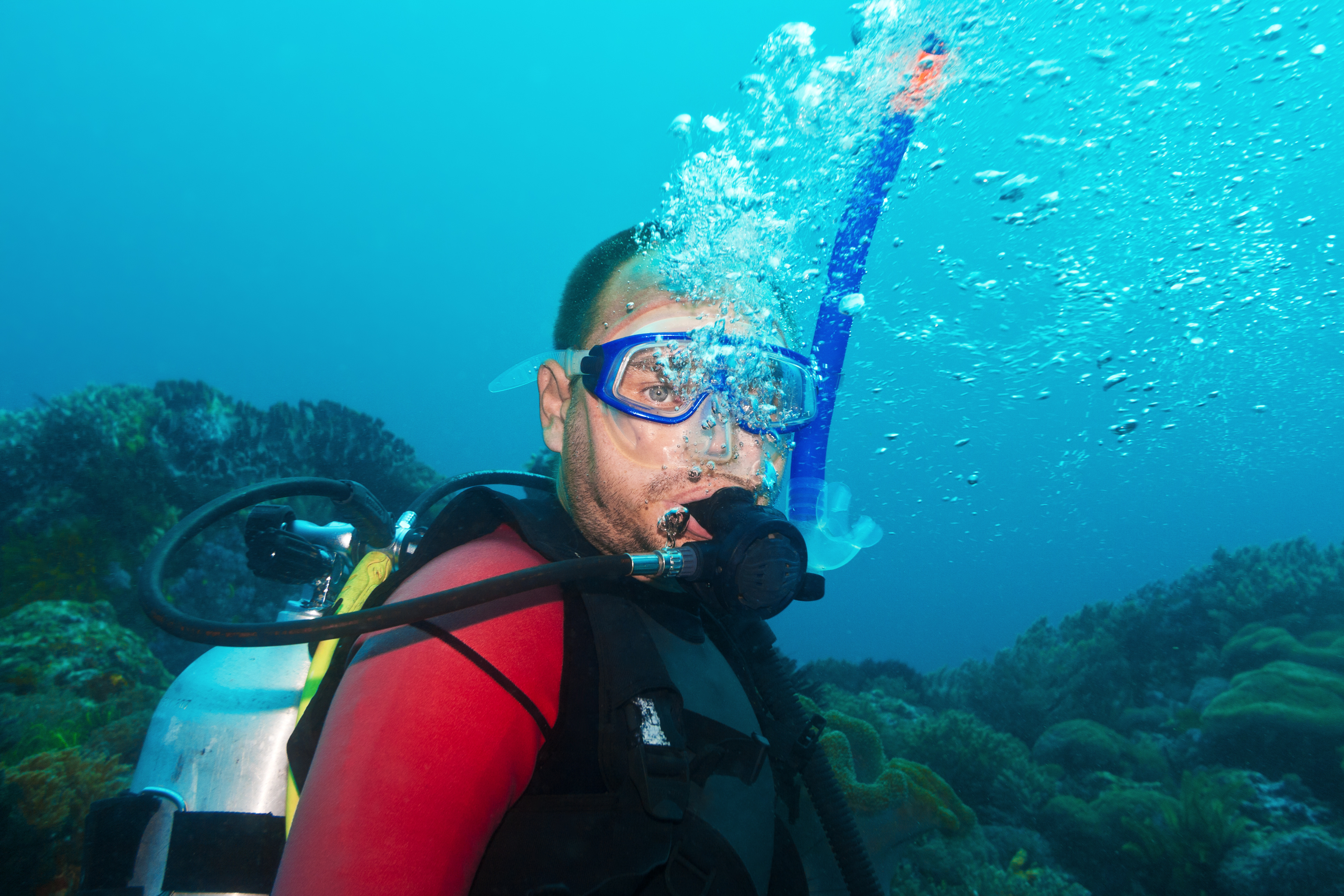 Older male diver in excellent health continues to enjoy the sport of scuba diving despite his age