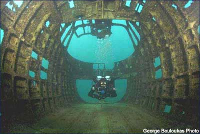 Diver swimming through an opening in the Sikorsky helicopter that rests between 25-55 feet of water at Dutch Springs in Bethlehem, Pennsylvania